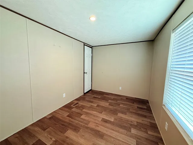 a view of room with wooden floor