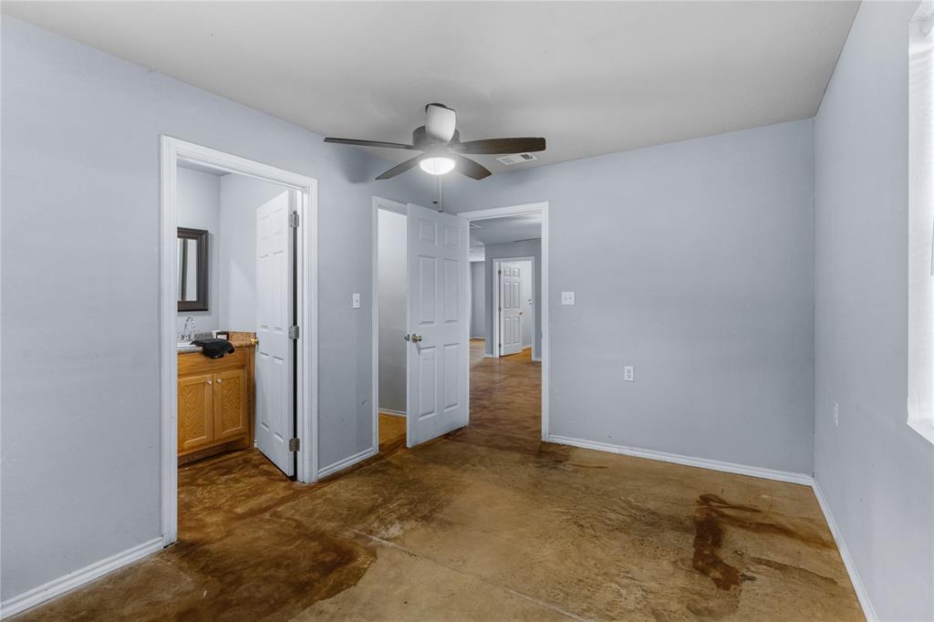 702 Main Windom, TX 75492 - Photo 11 of 30 an empty room with closet and a ceiling fan