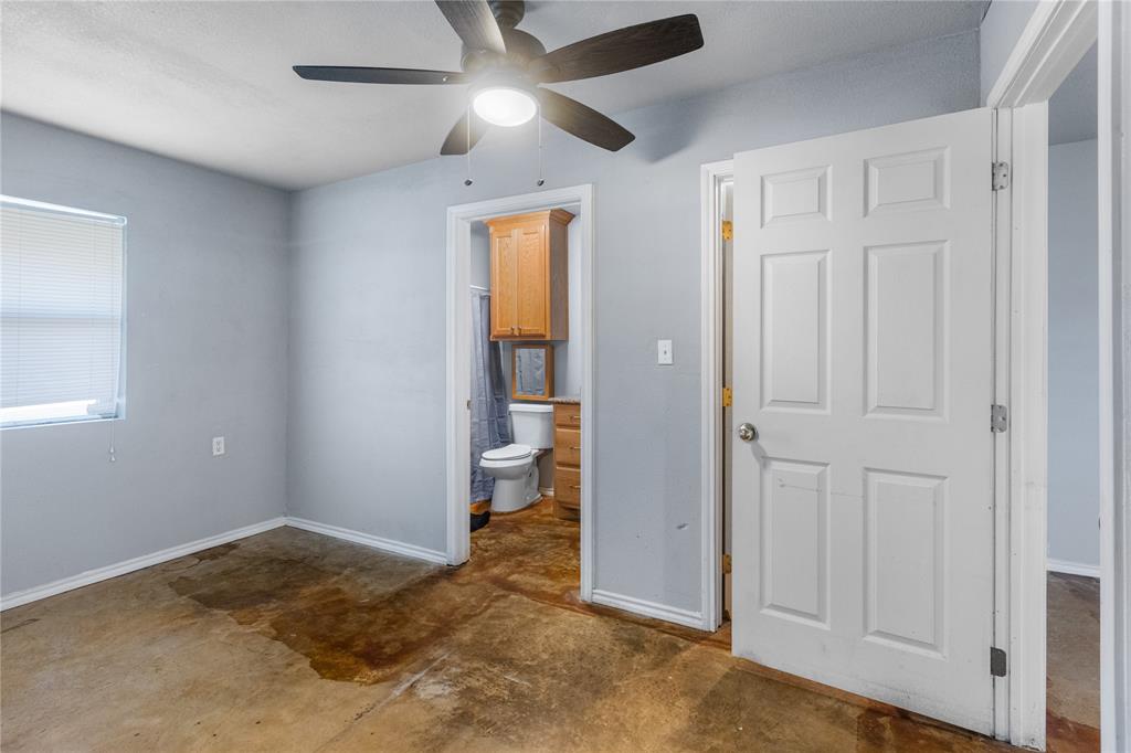 702 Main Windom, TX 75492 - Photo 12 of 30 an empty room with closet and a chandelier fan