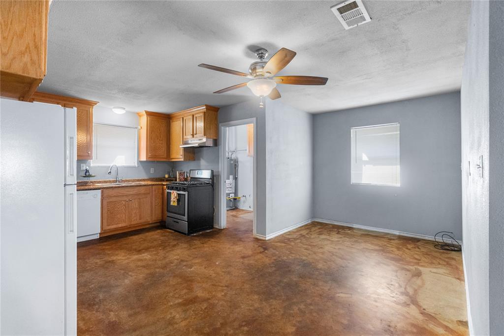 702 Main Windom, TX 75492 - Photo 5 of 30 a kitchen with a stove a sink and a refrigerator