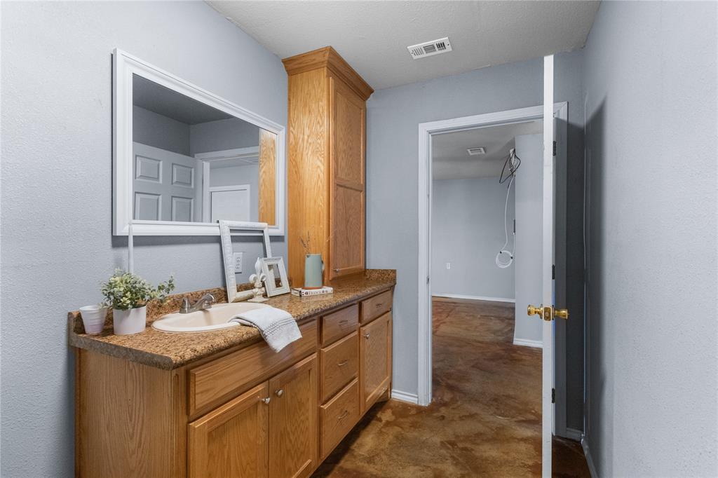 702 Main Windom, TX 75492 - Photo 10 of 30 a bathroom with a sink vanity and mirror