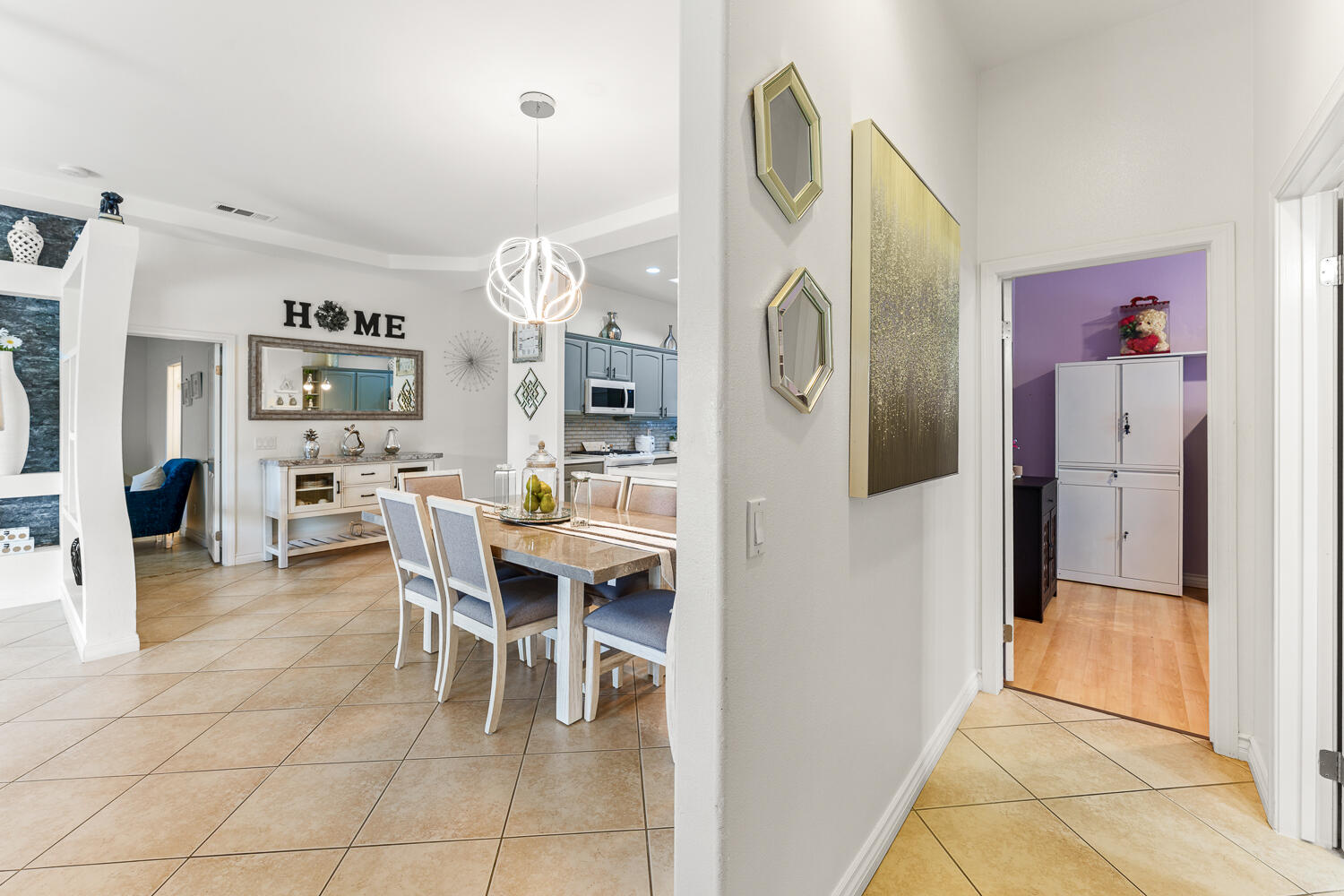 67305 Medano Road Cathedral City, CA 92234 - Photo 20 of 37 a dining room with furniture a large mirror and a view of kitchen