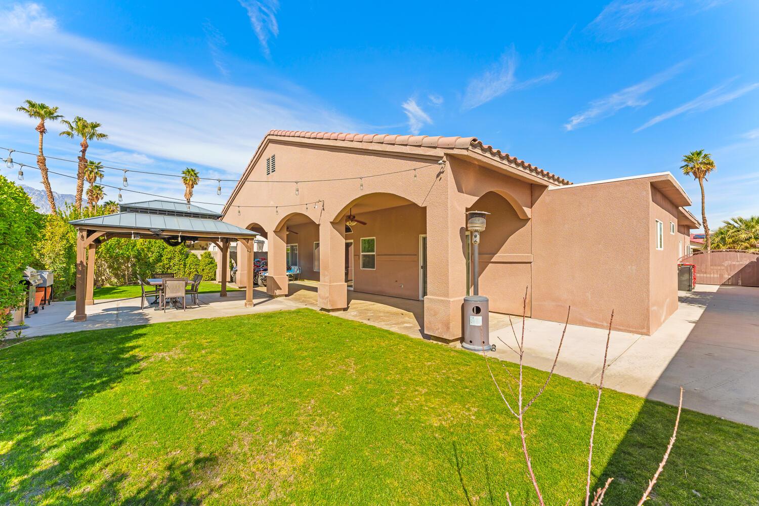 67305 Medano Road Cathedral City, CA 92234 - Photo 27 of 37 a view of a house with backyard porch and sitting area
