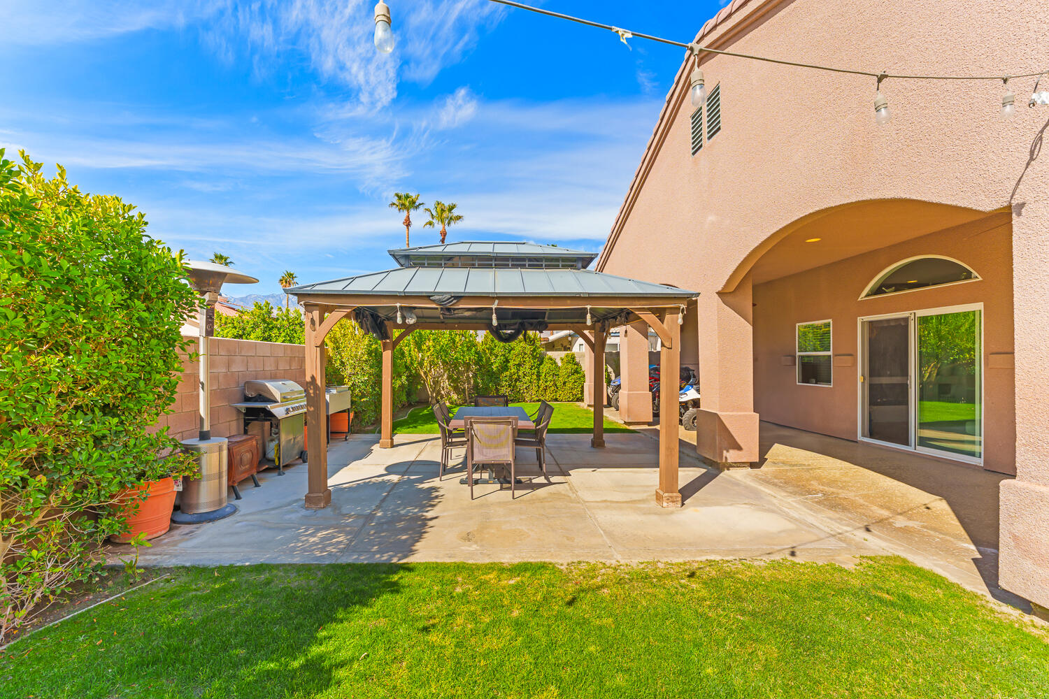 67305 Medano Road Cathedral City, CA 92234 - Photo 28 of 37 a backyard of a house with a table and chairs