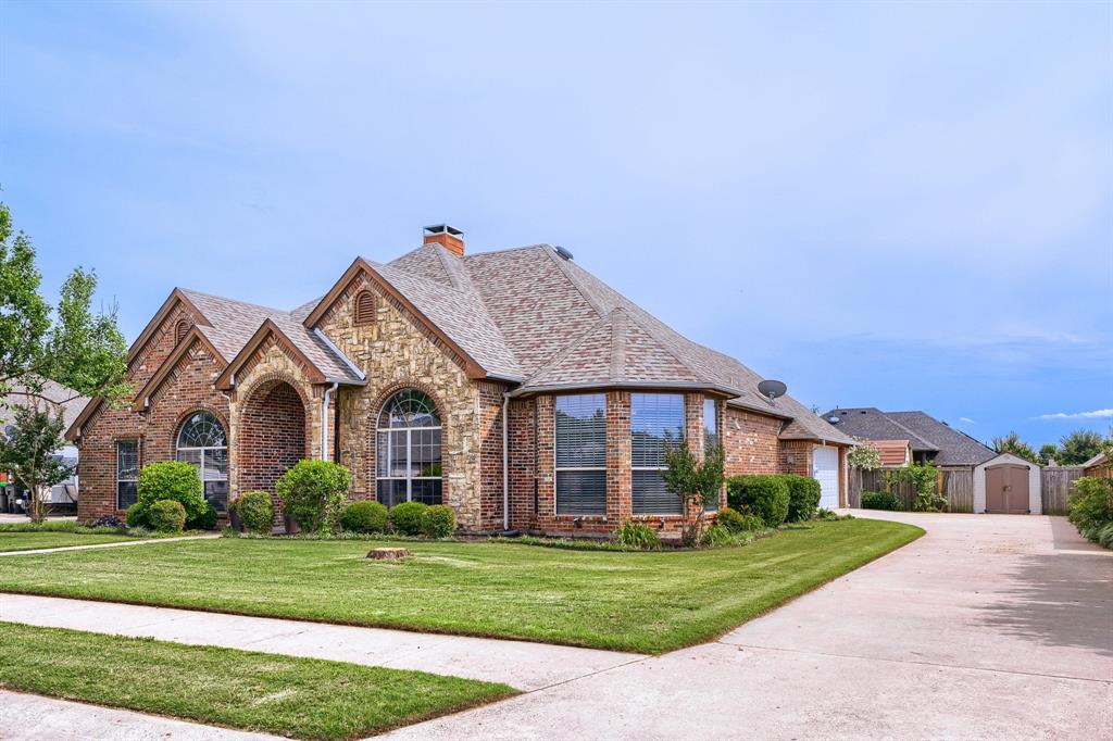 603 Ash Street Pilot Point, TX 76258 - Photo 3 of 28 Brick and stone facade residence featuring arched entryways and a prominent bay window