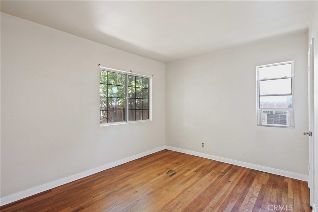 5940 Cedros Avenue Van Nuys, CA 91411 - Photo 15 of 23 an empty room with wooden floor and windows