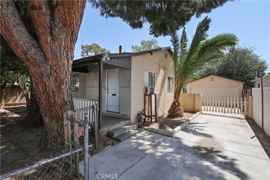 5940 Cedros Avenue Van Nuys, CA 91411 - Photo 2 of 23 a view of a house with a small yard and a large tree
