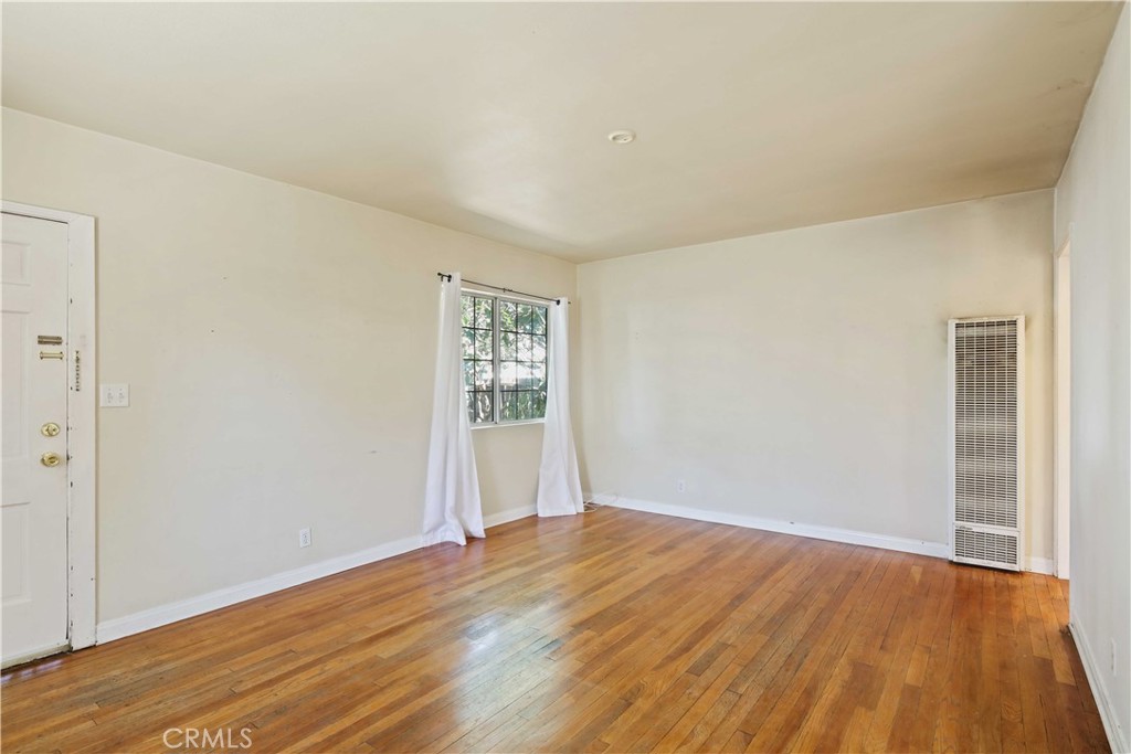 5940 Cedros Avenue Van Nuys, CA 91411 - Photo 4 of 23 an empty room with wooden floor and windows