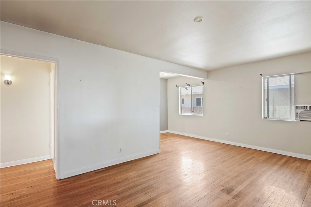 5940 Cedros Avenue Van Nuys, CA 91411 - Photo 6 of 23 a view of an empty room with wooden floor and a window