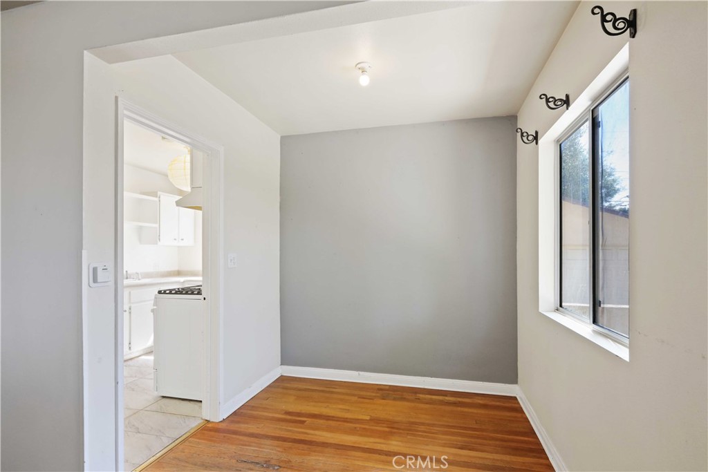5940 Cedros Avenue Van Nuys, CA 91411 - Photo 7 of 23 a view of an empty room with wooden floor and a window