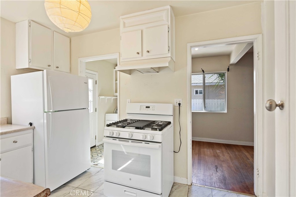 5940 Cedros Avenue Van Nuys, CA 91411 - Photo 8 of 23 a kitchen with white cabinets and white appliances