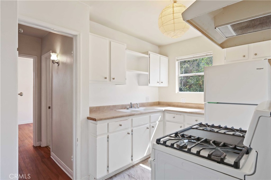 5940 Cedros Avenue Van Nuys, CA 91411 - Photo 9 of 23 a kitchen with sink a stove and a refrigerator