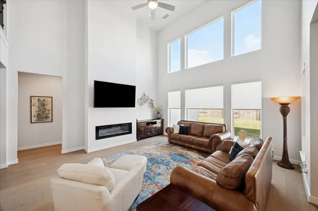 a living room with furniture a flat screen tv and a fireplace