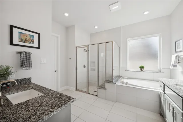 a spacious bathroom with a granite countertop sink and a mirror
