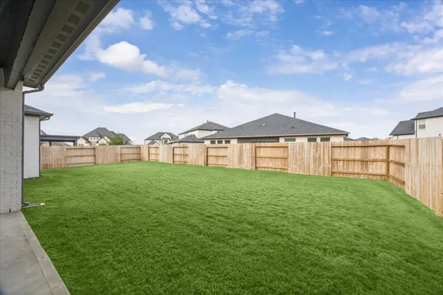 a view of a backyard of the house