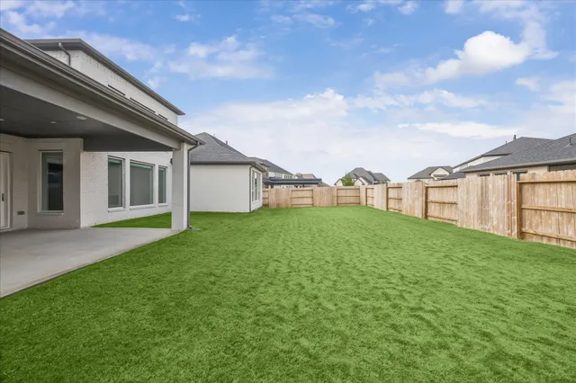 a view of a house with backyard and garden