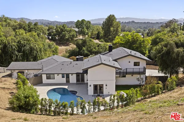 a aerial view of a house next to a yard