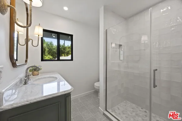 a view of a kitchen with a sink and a refrigerator