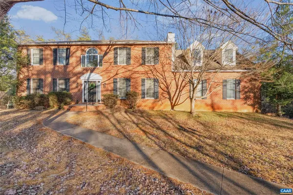 a view of a yard with wooden fence