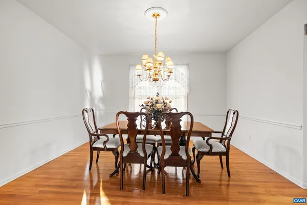 a kitchen with stainless steel appliances granite countertop a sink a stove and a granite counter tops with wooden floors