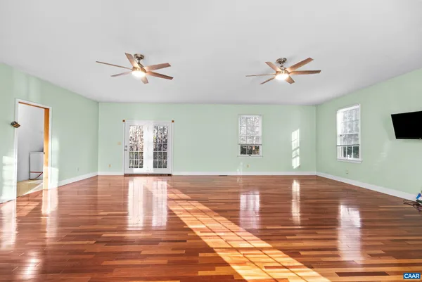 a spacious bedroom with a bed and a chandelier