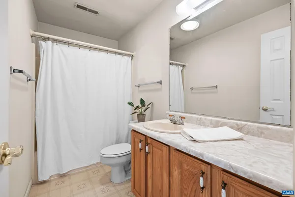 a living room with furniture and wall painting