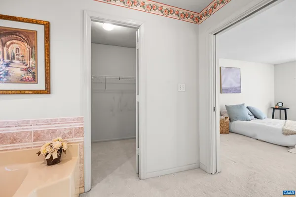 an empty room with chandelier fan and windows