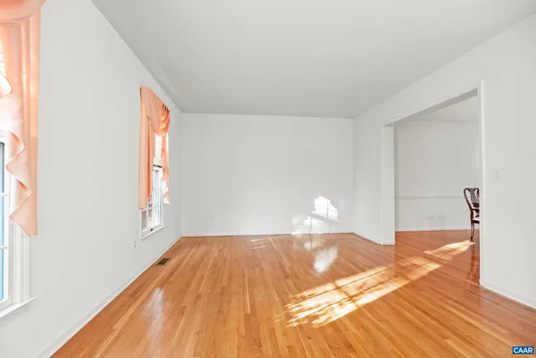 a view of a dining room with furniture and window