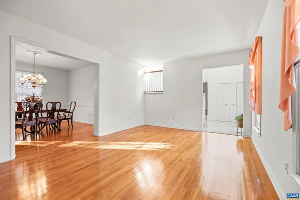 a view of a dining room with furniture and chandelier