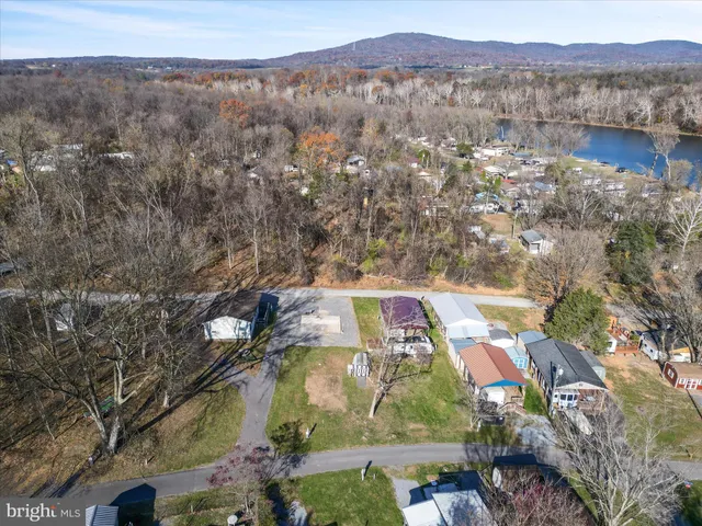 an aerial view of a house with a lake view