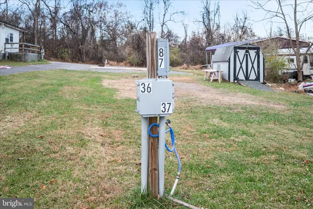 a sign board with yard in front of it