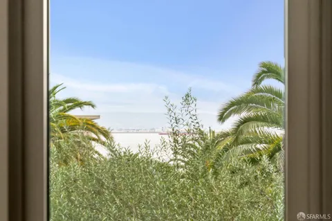 a living room with furniture a rug and a mirror