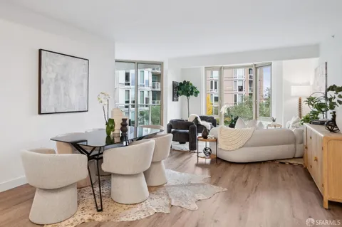 a kitchen with stainless steel appliances granite countertop a refrigerator sink and white cabinets