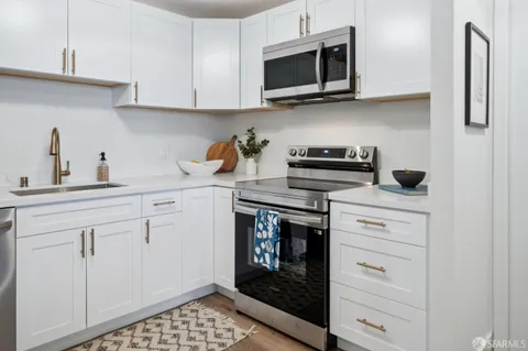 a kitchen with a sink cabinets and appliances