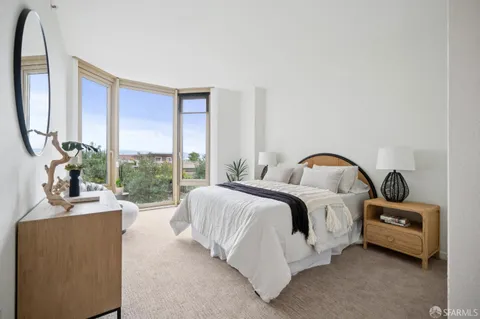 a bedroom with a bed and a potted plant