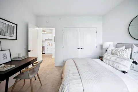 a white bath tub sitting next to a white sink and a shower