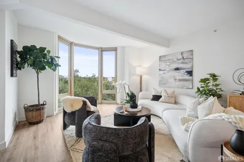 a living room with furniture and a potted plant