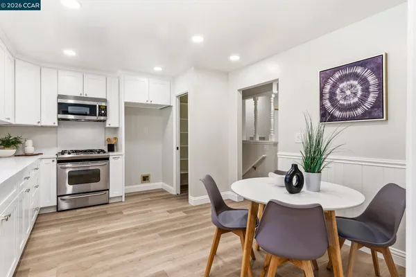 a view of a kitchen with a sink and wooden floor