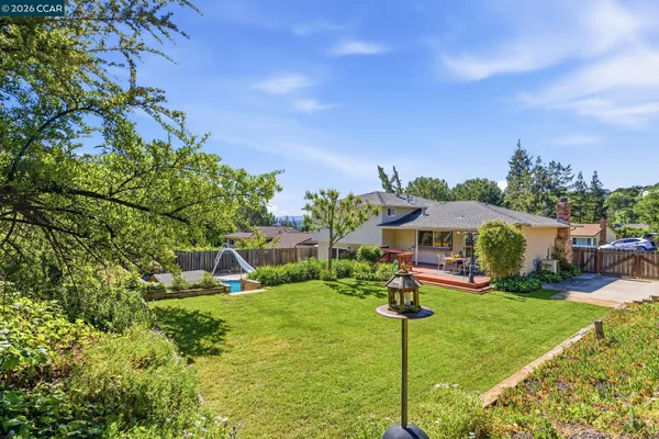 a view of a house with a yard patio and fire pit