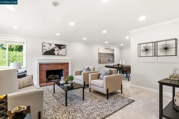 a living room with furniture a window and a table