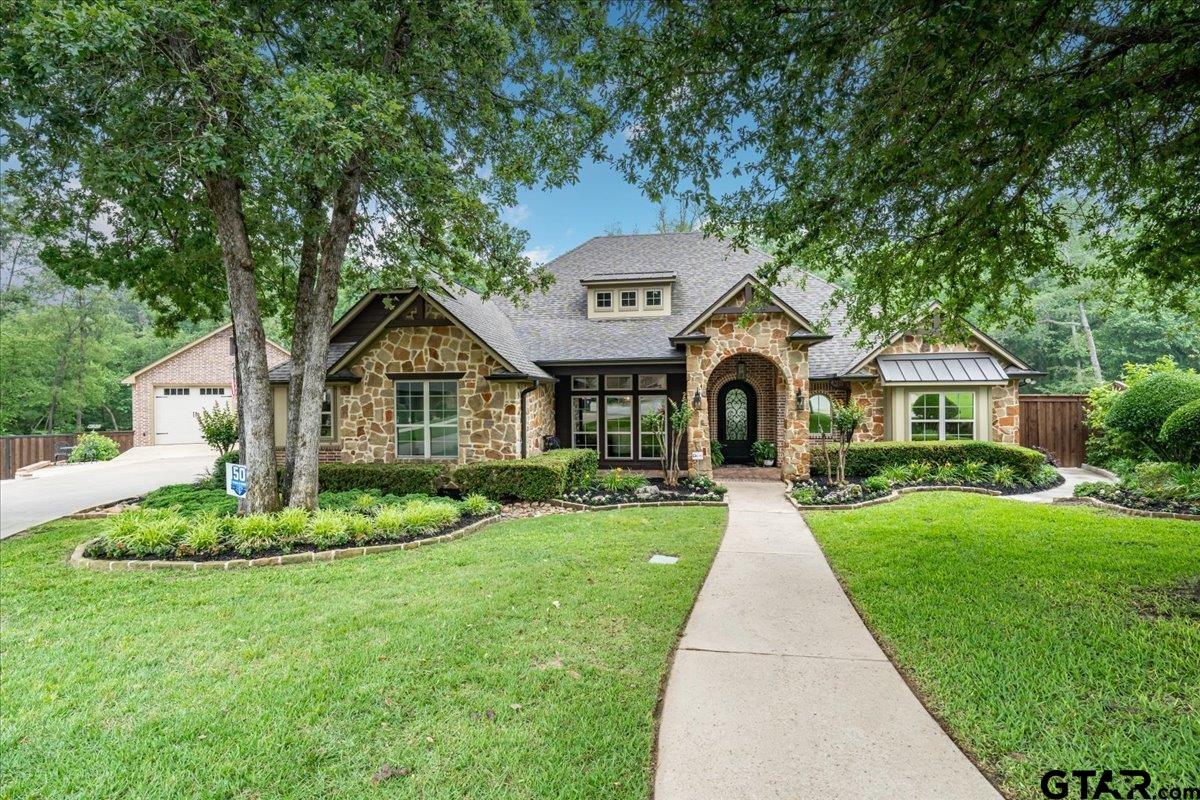 6527 Rochester Way Tyler, TX 75703 - Photo 1 of 48 a front view of a house with a yard and porch