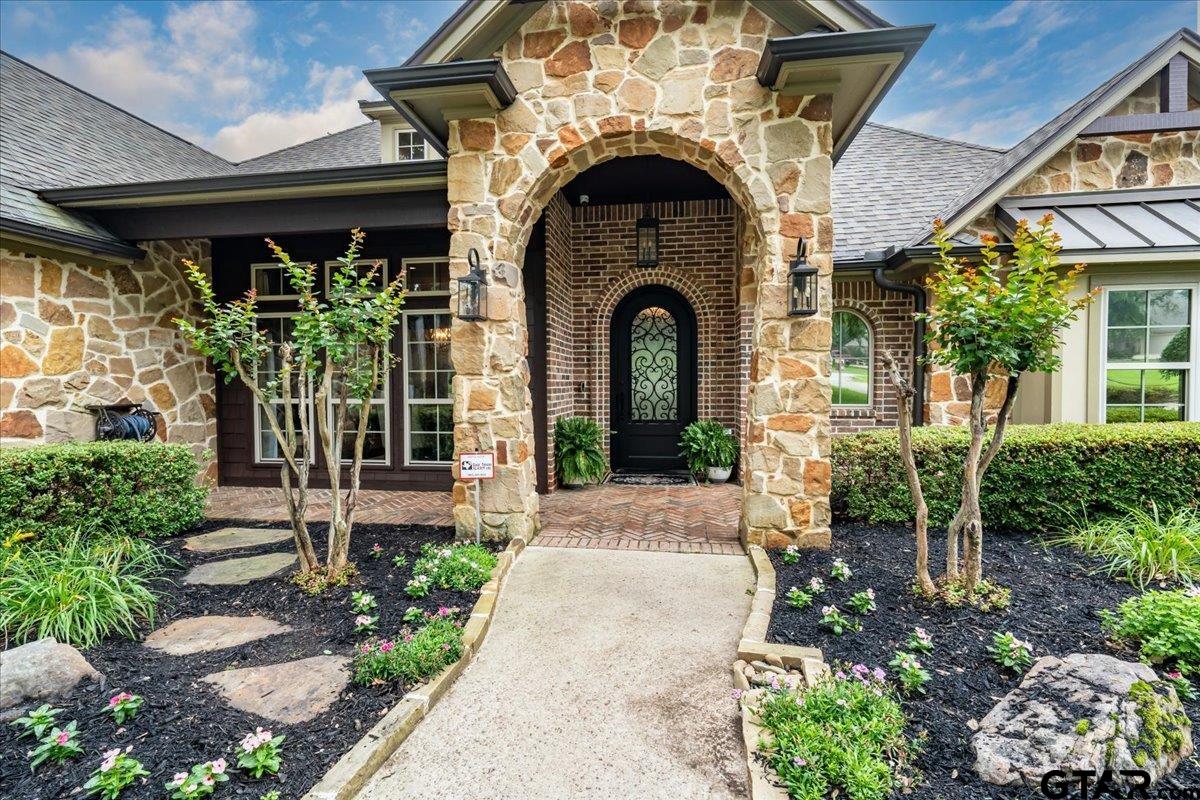 6527 Rochester Way Tyler, TX 75703 - Photo 2 of 48 a front view of a house with garden