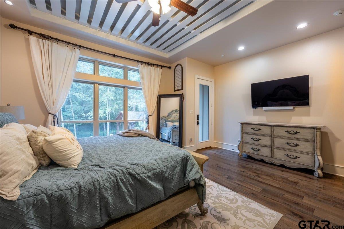 6527 Rochester Way Tyler, TX 75703 - Photo 21 of 48 a bedroom with a bed and flat screen tv