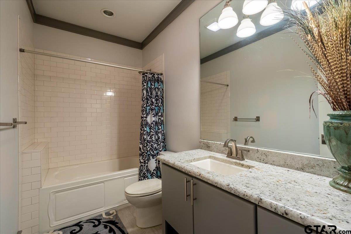 6527 Rochester Way Tyler, TX 75703 - Photo 28 of 48 a bathroom with a granite countertop sink toilet and shower