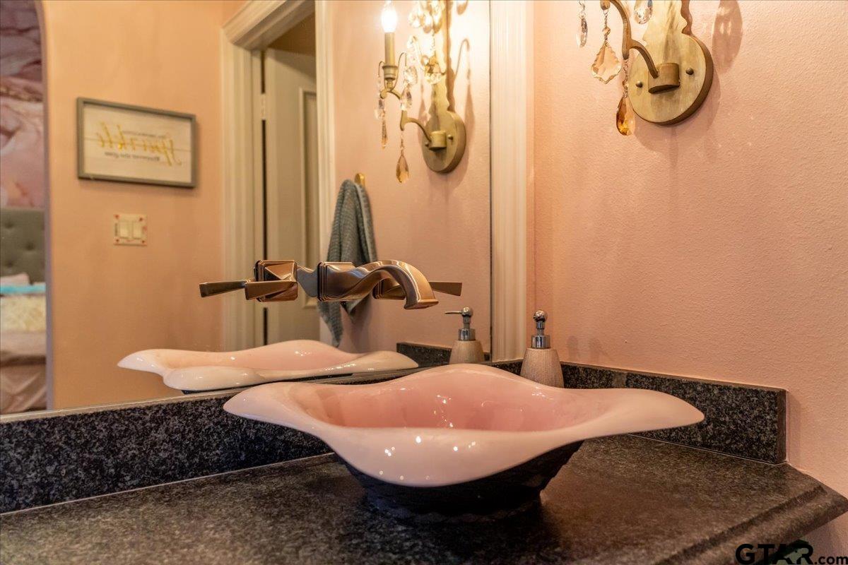 6527 Rochester Way Tyler, TX 75703 - Photo 32 of 48 a bathroom with a sink and mirror