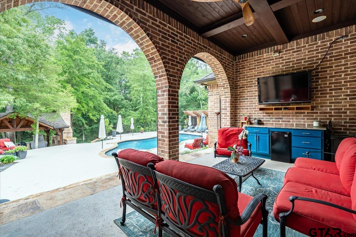 6527 Rochester Way Tyler, TX 75703 - Photo 35 of 48 a outdoor space with patio furniture and a fireplace
