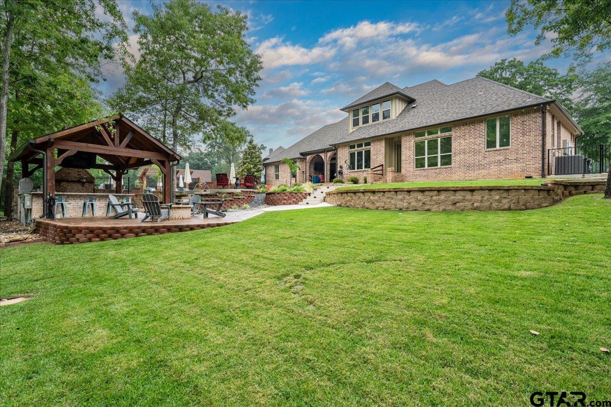 6527 Rochester Way Tyler, TX 75703 - Photo 37 of 48 a front view of a house with a garden