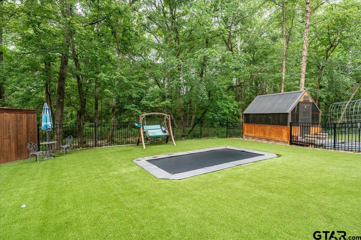 6527 Rochester Way Tyler, TX 75703 - Photo 43 of 48 a view of a backyard with swimming pool