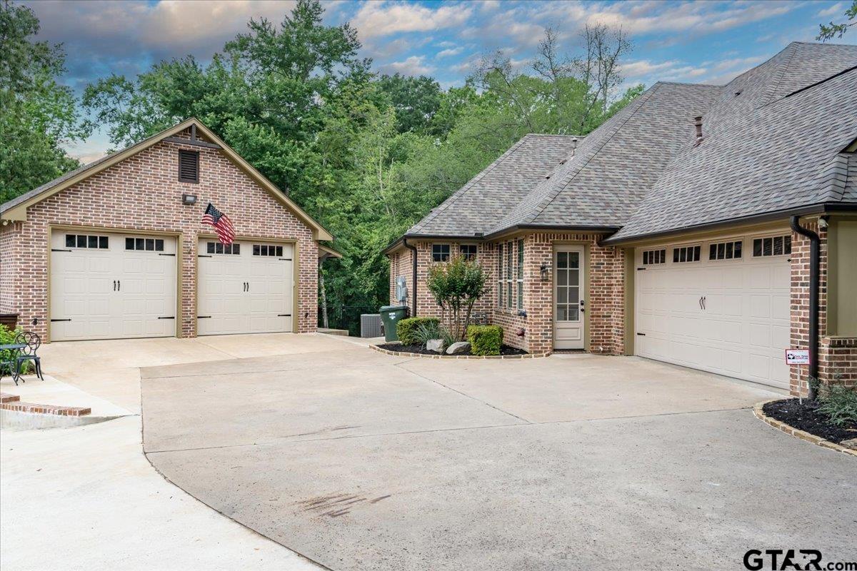 6527 Rochester Way Tyler, TX 75703 - Photo 47 of 48 a view of a house with backyard and garage