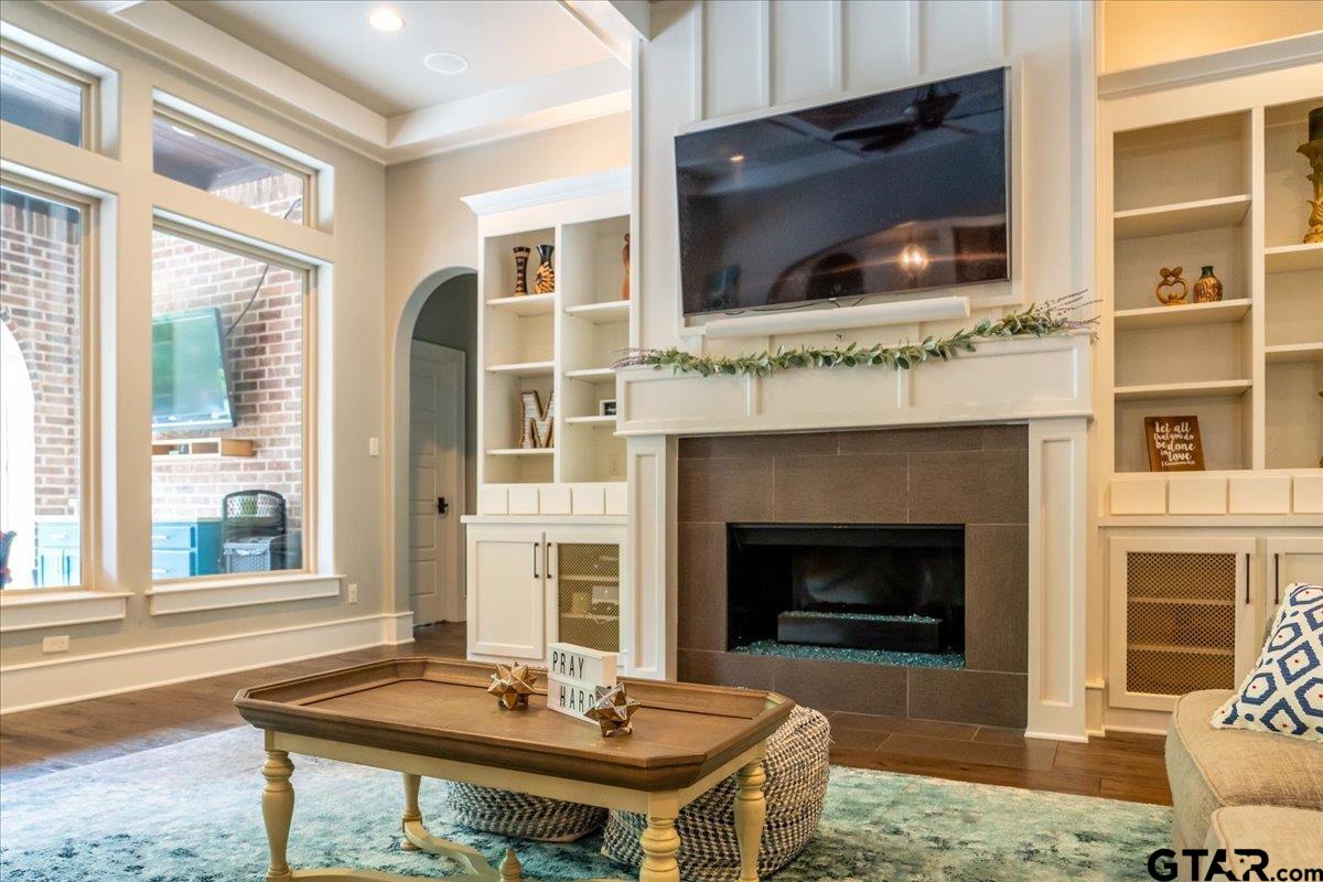 6527 Rochester Way Tyler, TX 75703 - Photo 5 of 48 a living room with a fireplace and a flat screen tv